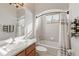 Bright bathroom featuring a vanity with a sink, a mirror, and a bathtub with tiled walls and a shower curtain at 12420 Aster Ave, Bradenton, FL 34212