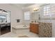 A relaxing bathroom offering a soaking tub, shower, and wood cabinets at 12420 Aster Ave, Bradenton, FL 34212