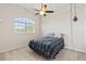 Bedroom with a unique ceiling fan and a sunlit window, adding charm and character to the space at 12420 Aster Ave, Bradenton, FL 34212