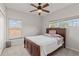 Bedroom with a ceiling fan, a window view, and a bed, providing comfort and natural light at 12420 Aster Ave, Bradenton, FL 34212