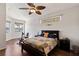 Bright bedroom with lake views, wood floors, and a ceiling fan for added comfort at 12420 Aster Ave, Bradenton, FL 34212