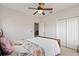 Bedroom featuring a ceiling fan, ample natural light, and closet space for a comfortable retreat at 12420 Aster Ave, Bradenton, FL 34212