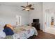 Bright bedroom featuring a ceiling fan, dark wood floors, and neutral walls at 12420 Aster Ave, Bradenton, FL 34212