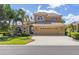 Charming two-story home with a well-manicured lawn, palm trees and a spacious two car garage at 12420 Aster Ave, Bradenton, FL 34212