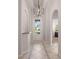 Elegant foyer with arched doorways, decorative tile flooring, and a modern chandelier creates a grand entrance at 12420 Aster Ave, Bradenton, FL 34212