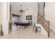 Spacious game room featuring a fireplace, pool table, and staircase, ideal for entertainment and Gathering fun at 12420 Aster Ave, Bradenton, FL 34212