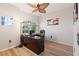 Office space featuring desk, wood floors, ceiling fan, and a large window, creating a productive and inviting work environment at 12420 Aster Ave, Bradenton, FL 34212