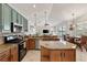 A modern eat-in kitchen boasts granite countertops, stainless steel appliances, and stylish pendant lighting at 12420 Aster Ave, Bradenton, FL 34212