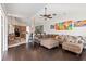 Spacious living room featuring an open concept with dark wood flooring and a large sectional couch at 12420 Aster Ave, Bradenton, FL 34212