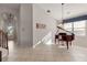 Open-concept living room showcasing a grand piano and tile floors at 12420 Aster Ave, Bradenton, FL 34212