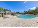 Community pool with lounge chairs, clubhouse and a water play area under a clear blue sky at 12420 Aster Ave, Bradenton, FL 34212