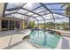Beautiful screened-in pool area with a view of a lush landscape and a tranquil lake at 12420 Aster Ave, Bradenton, FL 34212