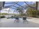 Screened-in pool offers relaxing lounge chairs and a scenic view of the lake at 12420 Aster Ave, Bradenton, FL 34212