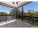 An outdoor screened in balcony with a tiled floor and wrought iron railing, perfect for entertaining at 13414 Goldfinch Dr, Lakewood Ranch, FL 34202