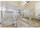 Well-maintained bathroom featuring a vanity with granite countertop and shower with tile surround at 13414 Goldfinch Dr, Lakewood Ranch, FL 34202
