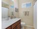 Cozy bathroom with warm-toned walls, wood vanity, and a shower-tub combination at 13414 Goldfinch Dr, Lakewood Ranch, FL 34202
