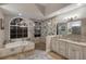 Luxurious bathroom featuring a soaking tub, a glass-enclosed shower, and elegant countertops at 13414 Goldfinch Dr, Lakewood Ranch, FL 34202