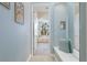 Hallway view of luxurious bathroom featuring an arch window above the tub at 13414 Goldfinch Dr, Lakewood Ranch, FL 34202