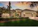 Beautiful, upgraded exterior featuring a manicured lawn and lush tropical landscaping at 13414 Goldfinch Dr, Lakewood Ranch, FL 34202