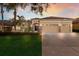 Gorgeous home exterior with manicured lawn, mature trees, elegant landscaping, and a spacious driveway at 13414 Goldfinch Dr, Lakewood Ranch, FL 34202