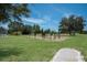 Outdoor fitness area featuring various exercise bars and equipment surrounded by green space at 13414 Goldfinch Dr, Lakewood Ranch, FL 34202