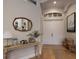 Bright foyer with wood floors, a decorative mirror, stylish console table, and a view of the front door at 13414 Goldfinch Dr, Lakewood Ranch, FL 34202