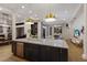Open-concept kitchen with a large island, stainless steel appliances, and modern pendant lighting at 13414 Goldfinch Dr, Lakewood Ranch, FL 34202