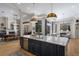 Open kitchen featuring a large island, hardwood floors, and views of the dining and living rooms at 13414 Goldfinch Dr, Lakewood Ranch, FL 34202