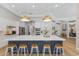 Kitchen island with blue cabinets, white countertop, and white and wooden chairs at 13414 Goldfinch Dr, Lakewood Ranch, FL 34202