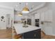 Bright kitchen with stainless steel appliances, a large island, and modern pendant lighting at 13414 Goldfinch Dr, Lakewood Ranch, FL 34202
