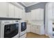 Laundry room with white cabinets, sink, and Maytag washer and dryer at 13414 Goldfinch Dr, Lakewood Ranch, FL 34202