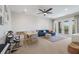Spacious living area with neutral carpeting, a ceiling fan, comfortable seating and a walkout balcony at 13414 Goldfinch Dr, Lakewood Ranch, FL 34202
