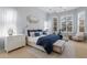 Serene main bedroom features a comfortable king-size bed and ample natural light from large windows at 13414 Goldfinch Dr, Lakewood Ranch, FL 34202
