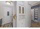 Mudroom with white cabinets and door, mosaic backsplash, and a patterned rug at 13414 Goldfinch Dr, Lakewood Ranch, FL 34202