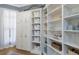 Pantry with white cabinets, shelves, and baskets at 13414 Goldfinch Dr, Lakewood Ranch, FL 34202