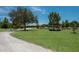 Scenic walking trail winds through a green lawn with a serene pond and lush trees at 13414 Goldfinch Dr, Lakewood Ranch, FL 34202