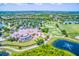Beautiful aerial view showcasing the community with lush landscaping, a golf course, and tranquil lakes at 13635 Legends Walk Ter, Lakewood Ranch, FL 34202