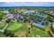 Stunning aerial view of a lush golf course community with a beautiful clubhouse and surrounding lakes at 13635 Legends Walk Ter, Lakewood Ranch, FL 34202