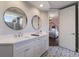 Beautiful bathroom with double sinks, mirrors, and a view into the bedroom at 13635 Legends Walk Ter, Lakewood Ranch, FL 34202