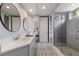 Contemporary bathroom featuring double sinks, tiled shower and a view to bedroom at 13635 Legends Walk Ter, Lakewood Ranch, FL 34202