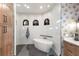 Modern bathroom with a soaking tub, frameless shower, and arched windows at 13635 Legends Walk Ter, Lakewood Ranch, FL 34202