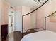 View of the bedroom with hardwood floors, leading to the bathroom with patterned tile flooring at 13635 Legends Walk Ter, Lakewood Ranch, FL 34202