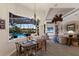 Dining room with pool view, chandelier and ceiling fan, adjacent to the kitchen at 13635 Legends Walk Ter, Lakewood Ranch, FL 34202