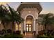 Elegant home entryway with a double door, decorative columns, and manicured landscaping at 13635 Legends Walk Ter, Lakewood Ranch, FL 34202