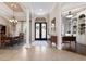 Inviting foyer with tile flooring, dining area, and office space with built-in shelves at 13635 Legends Walk Ter, Lakewood Ranch, FL 34202
