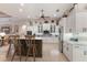 Large kitchen island with seating, white cabinets, and stainless steel appliances at 13635 Legends Walk Ter, Lakewood Ranch, FL 34202