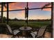 Seating area with a view of the golf course on the screened-in lanai at 13635 Legends Walk Ter, Lakewood Ranch, FL 34202