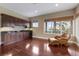 Extra living area features a wet bar, hardwood floors, and a view of the outdoors at 13635 Legends Walk Ter, Lakewood Ranch, FL 34202