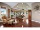 Open living room features hardwood floors, a ceiling fan, lots of natural light, and neutral wall colors at 13635 Legends Walk Ter, Lakewood Ranch, FL 34202
