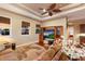 Comfortable living room featuring a ceiling fan, decorative rug, a television and lots of natural light at 13635 Legends Walk Ter, Lakewood Ranch, FL 34202